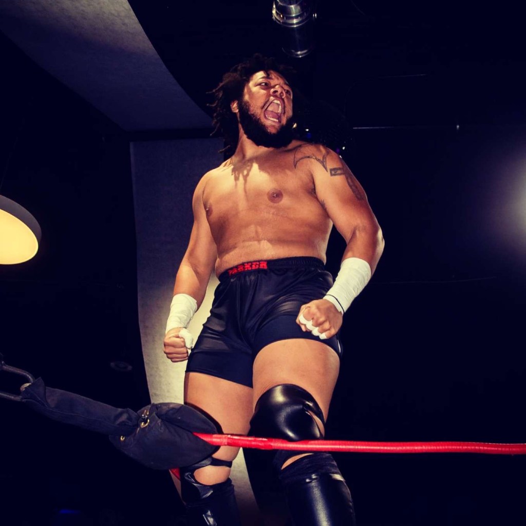 Wrestler Troy Parker stands tall in the ring during a match.