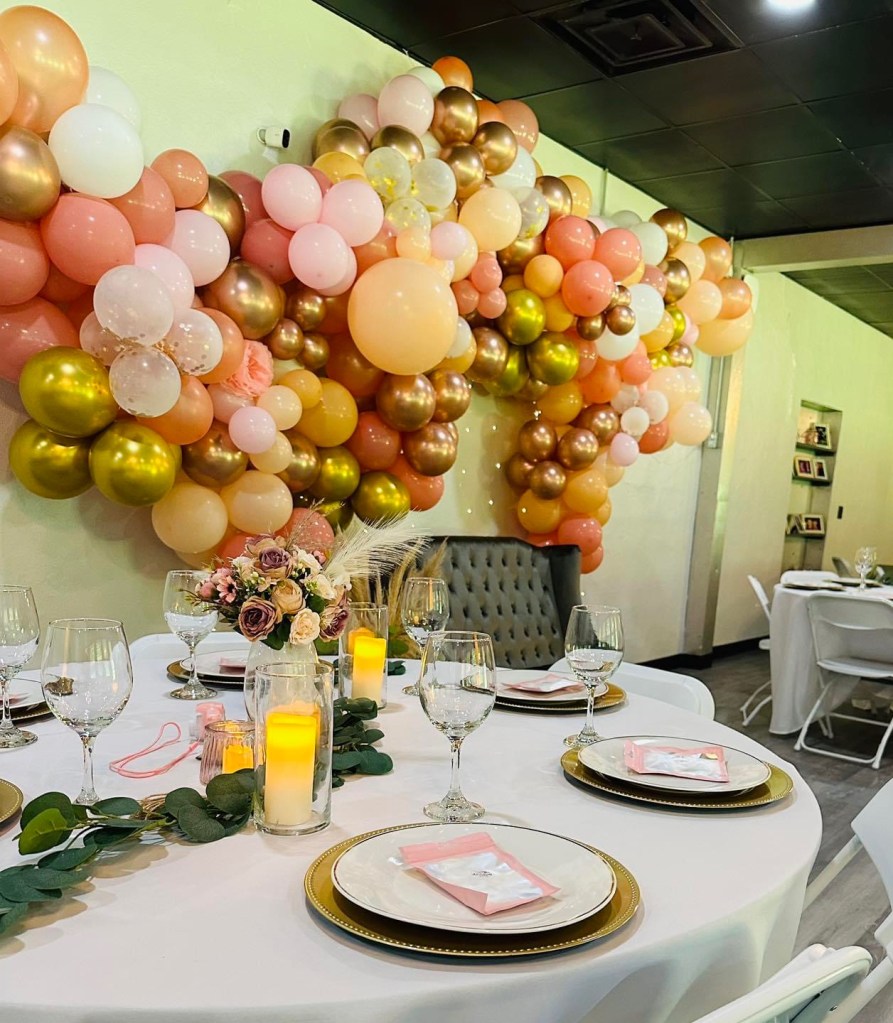 Decorative balloons, and table settings are pictured.