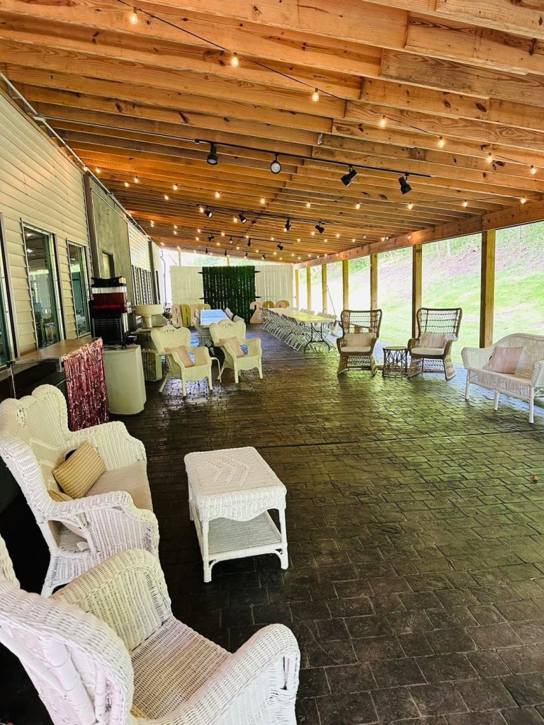 An outdoor patio area is pictured with tables and chairs.