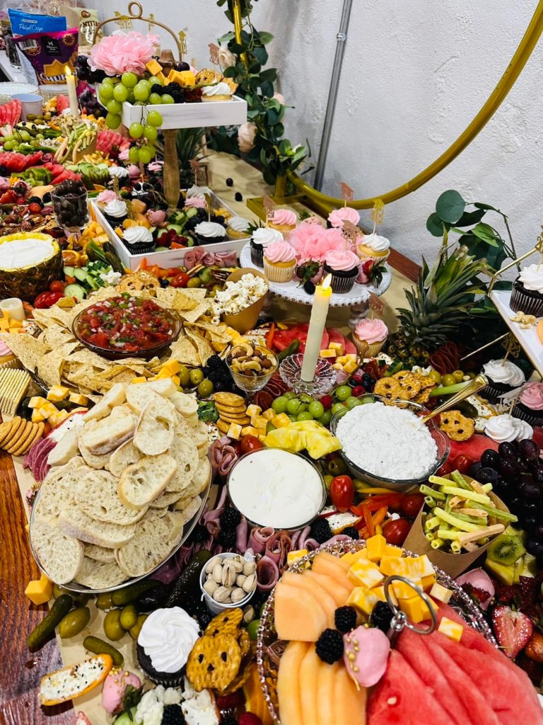A large spread of food and desserts is pictured.