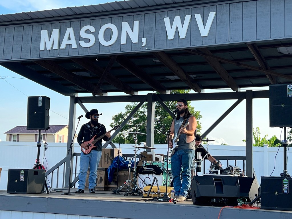 Two musicians perform on stage. 