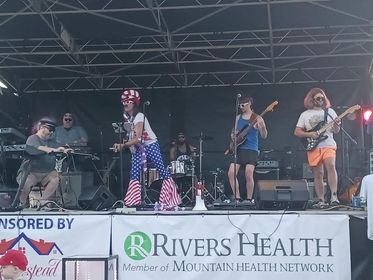 The M.F.B. play on the Riverfront Park stage, with lead singer in patriotic gear.