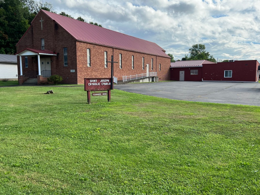 A photo of a brick church sits in the background.
