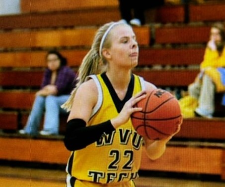 A female basketball player on the court. 