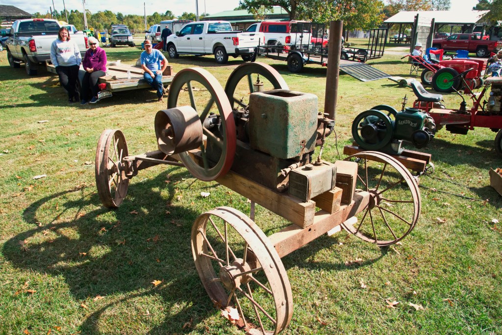 People observe the entries into the antique engine show.