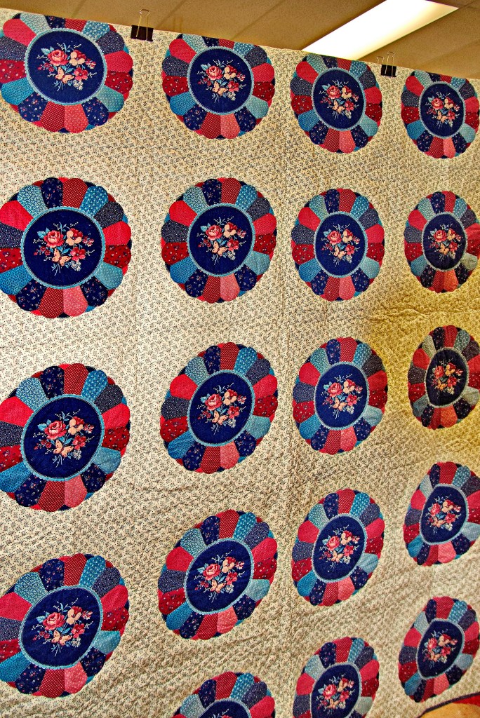 A large quilt made of colorful circles. 
