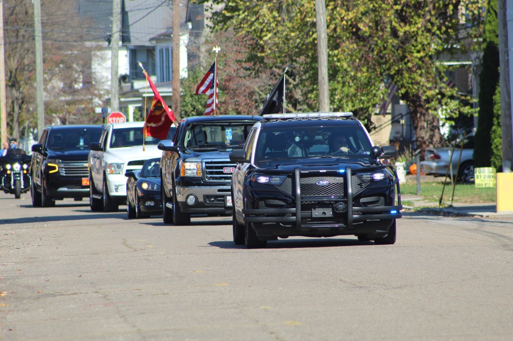 The Point PD lead off the parade, with a truck carrying the colors behind it.