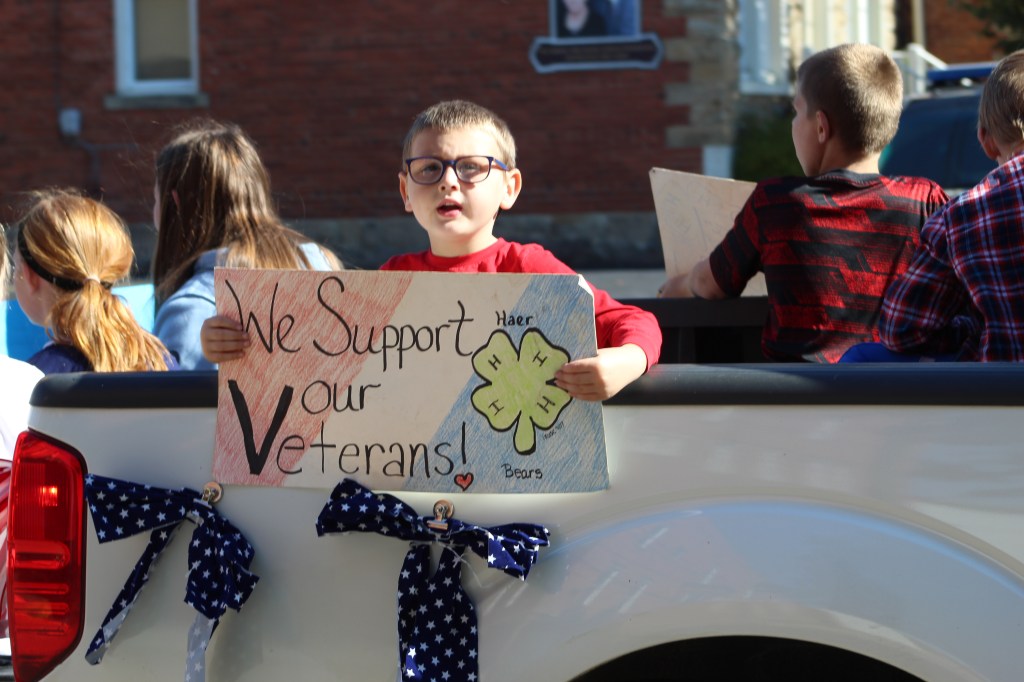 Haer Bears 4-H Club float and members holding signs.