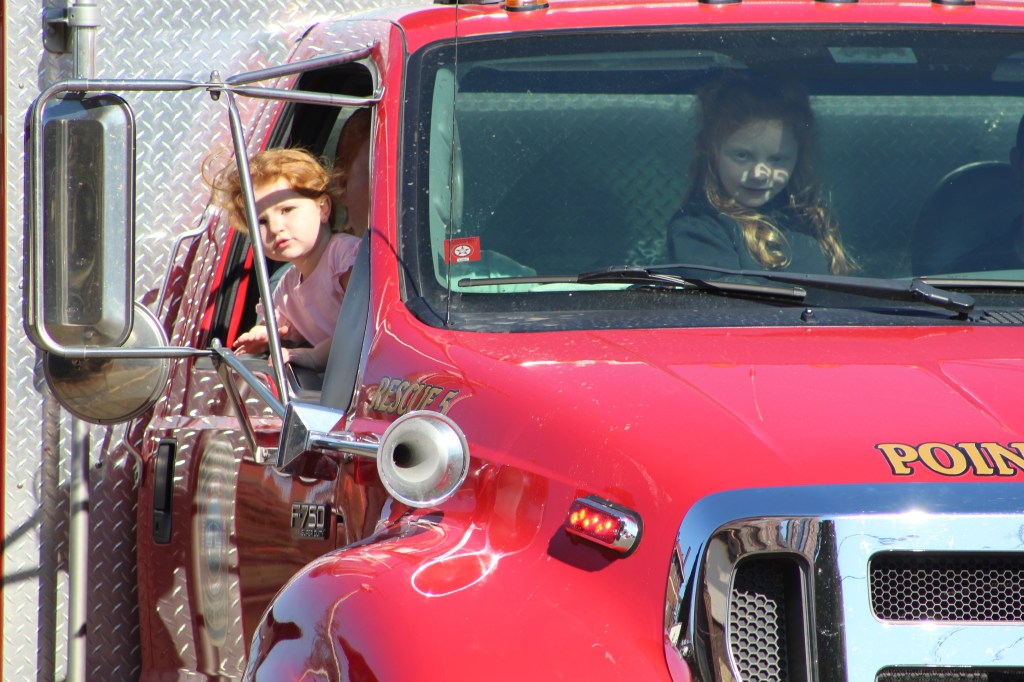 Young parade goers ride along in Point Pleasant Fire Department Truck.